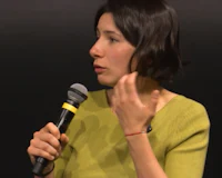 a woman talking into a microphone